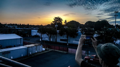 Man photographing at sunset