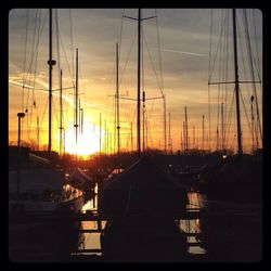 Boats at harbor during sunset