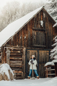 Portrait of young woman standing in barn