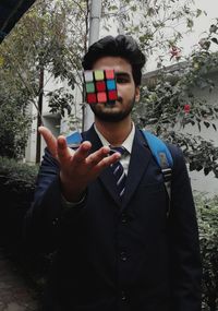 Portrait of young man standing at home