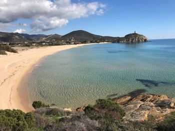 Scenic view of beach against cloudy sky