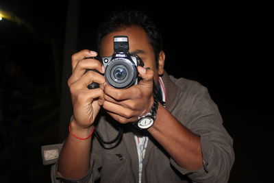 Man photographing from camera at night