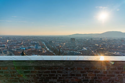 Aerial view of illuminated buildings in city against sky