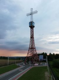 Low angle view of tower against cloudy sky