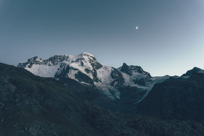 Scenic view of mountains against clear sky during sunset at swiss alps