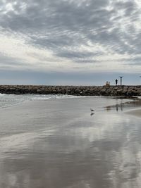 Scenic view of beach against sky during winter