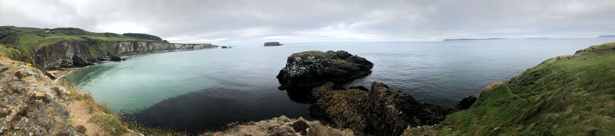 Panoramic shot of rocks on sea against sky