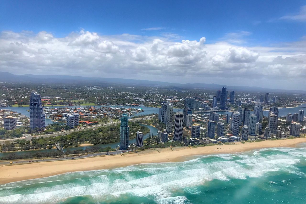 city, cityscape, architecture, cloud - sky, sky, skyscraper, building exterior, urban skyline, water, outdoors, aerial view, travel destinations, scenics, sea, built structure, downtown district, day, no people