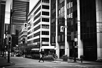 People walking on road against buildings