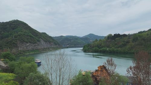 Scenic view of lake and mountains against sky