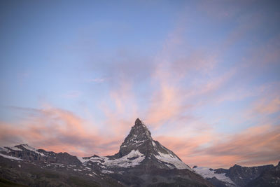 Scenic view of snowcapped mountains against sky during sunset