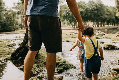 Father with children in the river