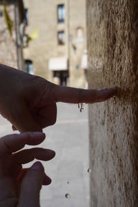 Close-up of hand touching wall