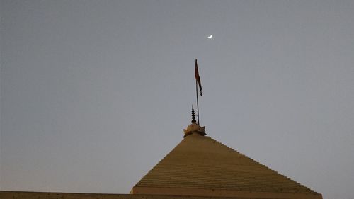 Low angle view of cross against clear sky