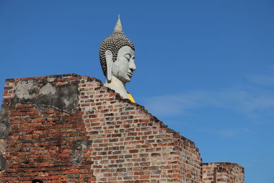 Low angle view of statue of building against sky