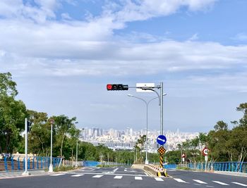 Traffic on road against sky in city