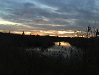 Scenic view of lake against sky during sunset