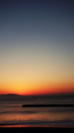 Scenic view of sea against clear sky during sunset