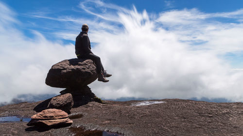 Rear view of man standing on rock