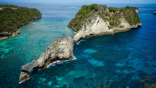 High angle view of rocks on sea shore