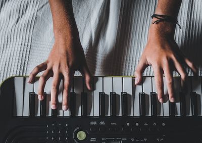 Close-up of hands playing piano