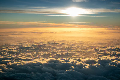 Sunset in the clouds as we descend over the mediterranean sea into catania 
