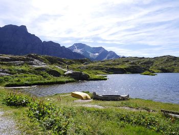 Calm lake against countryside landscape