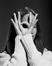 Close-up of woman hand against black background