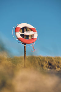 Low angle view of basketball hoop against clear blue sky