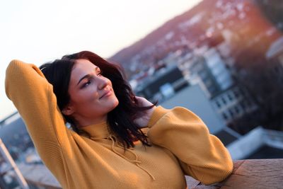 Portrait of smiling young woman in city