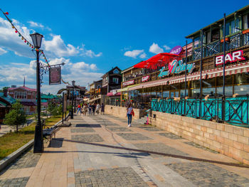 People walking on footpath in city