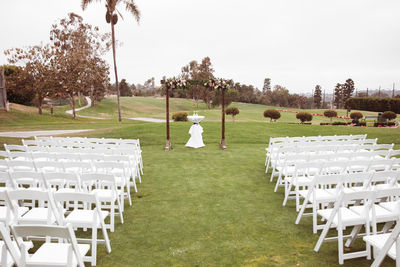 Outdoor wedding ceremony on a cloudy rainy day - wooden square arch with floral arrangements