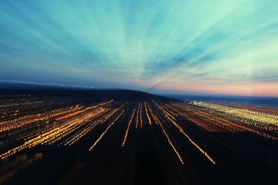 Aerial view of illuminated road against sky at night