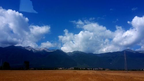 Scenic view of mountains against cloudy sky