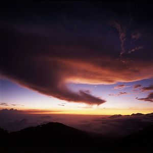 Scenic view of mountains against cloudy sky