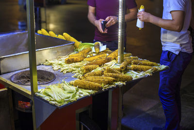 Low section of men by market stall