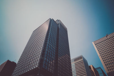 Low angle view of skyscrapers against clear sky