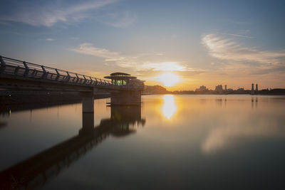 Bridge over lake at sunset