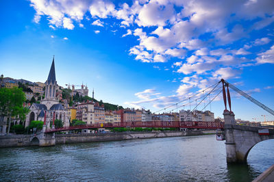 Bridge over river with buildings in background