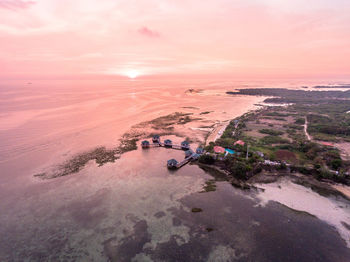 Aerial view of sea against sky during sunset