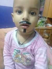 Close-up portrait of cute boy at home