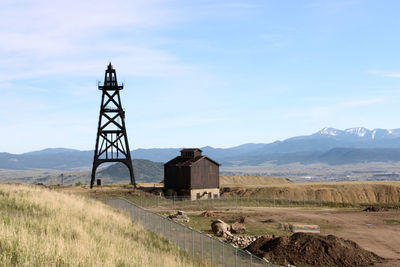 Built structure on field against sky