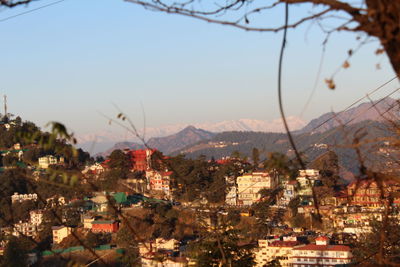 High angle view of townscape and mountains against sky