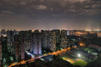 High angle view of illuminated buildings against sky at night