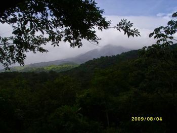 Scenic view of mountains against cloudy sky