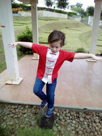 Boy practicing kung fu at yard