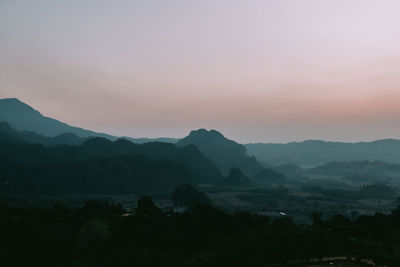 Scenic view of silhouette mountains against sky during sunset