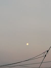 Low angle view of cables against clear sky