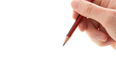 Close-up of hand holding pen over white background