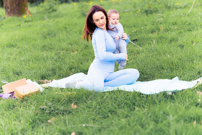 Smiling young woman standing on grass in field